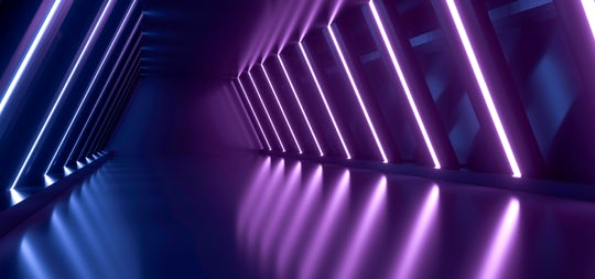 abstract image of a hallway with blue and purple lighting strips lighting the walls.