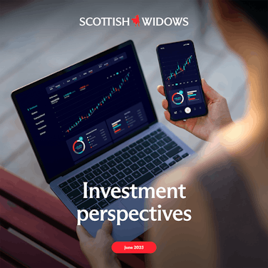 A person uses a laptop and smartphone displaying financial growth charts and dashboards, analysing data in a modern setting