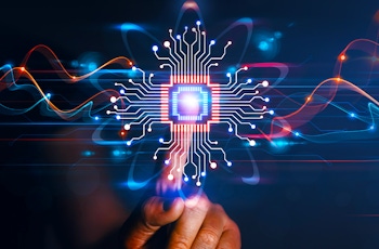 A hand reaches out to touch a glowing microchip with circuitry, symbolising technology and innovation against a dark background