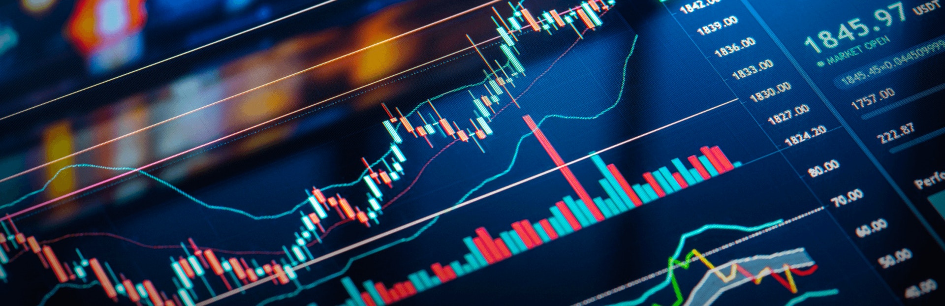 A close-up of a trading screen displaying colorful candlestick charts and indicators, indicating market trends and data analysis